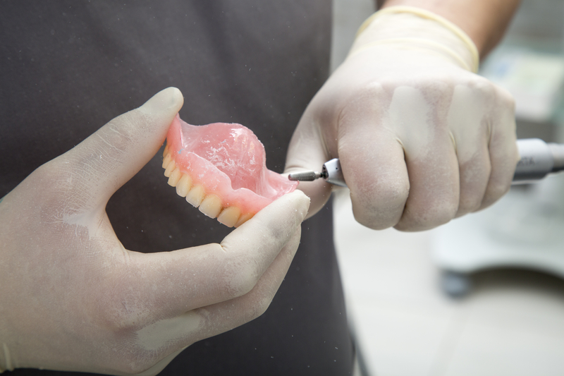 person repairing dentures